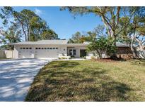 Updated single-story home with attached garage and landscaped lawn at 2940 Hadleigh Ct, Clearwater, FL 33761