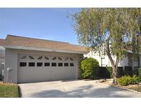 Attractive single-story home with a two-car garage and well-maintained landscaping at 5565 Salem Square N Dr, Palm Harbor, FL 34685