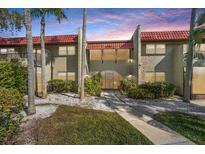 Charming townhome featuring a red tile roof, textured facade and a well-manicured lawn at 1003 S Bayshore Blvd # 206, Safety Harbor, FL 34695