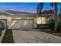 Front view of a charming villa with a two-car garage and manicured landscaping at 11575 Captiva Kay Dr, Riverview, FL 33569