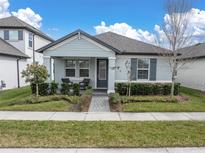 Charming single-story home with a well-manicured front yard, covered entryway, and a cozy front patio at 12099 Gavin Ln, Odessa, FL 33556