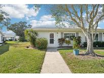 Charming single-story home with a well-manicured lawn and landscaped front yard, creating an inviting curb appeal at 301 Andover S Pl # 185, Sun City Center, FL 33573
