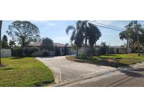 Ranch style home with a long driveway and mature landscaping at 5253 Dover Ne St, St Petersburg, FL 33703