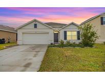 Charming one story home with a well-maintained lawn and a two car garage at 11976 Brighton Knoll Loop, Riverview, FL 33579