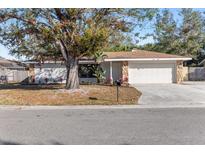 Charming single-Gathering home with a large front yard, stone accents, and a two-car garage at 1217 Carmella Ln, Sarasota, FL 34243