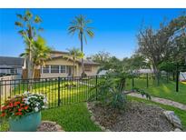 Charming house with a manicured lawn, walkway, and lush landscaping at 156 29Th N Ave, St Petersburg, FL 33704