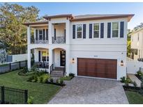 Stunning two-story home with a two-car garage, lush landscaping, and beautiful black shutters at 2810 W Alline Ave, Tampa, FL 33611