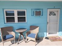 Inviting exterior seating area with wicker chairs, perfect for relaxing near the front door at 505 67Th Ave # 5, St Pete Beach, FL 33706