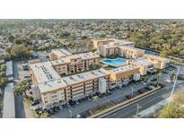 Expansive aerial view of a multi-unit residential community with a sparkling blue swimming pool at 5820 N Church Ave # 247, Tampa, FL 33614