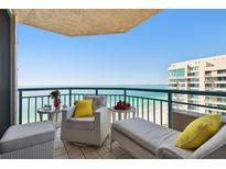 Relax on this tiled balcony with views of the ocean and comfortable outdoor furniture at 1540 Gulf Blvd # 1705, Clearwater, FL 33767