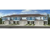 Modern townhouses with attached garages and neutral color scheme at 2073 Hallier Cv, Wesley Chapel, FL 33543