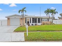 Single-story house with a well-maintained lawn and attached garage at 5152 Victoria Ln, Holiday, FL 34690
