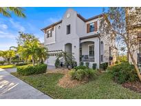 Stunning two-story home with lush landscaping, beautiful front lawn, and charming architectural details at 1021 Seagrape Dr, Ruskin, FL 33570