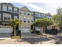 Charming townhome with well-maintained landscaping, two car garage and inviting curb appeal at 1442 Harbour Walk Rd, Tampa, FL 33602