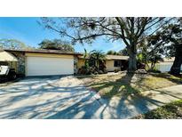 Charming single-story home with a well-manicured front yard and a two-car garage at 1670 Monterey Dr, Clearwater, FL 33756