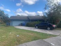 Ranch-style home with attached garage and driveway, needing landscaping at 3602 Southview Ct, Brandon, FL 33511