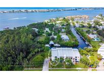 Beautiful waterfront property featuring a three-story building with lush landscaping and boating access to the open bay at 4212 126Th W St # 401, Cortez, FL 34215