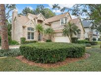 Brick home with landscaped yard and two-car garage at 4421 W Sevilla St, Tampa, FL 33629