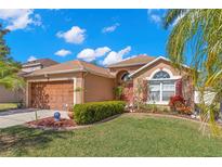 Charming single Gathering home featuring well-maintained landscaping, inviting curb appeal, and attached two-car garage at 6426 Gondola Dr, Riverview, FL 33578