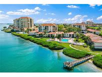 Beautiful aerial view of waterfront condos, featuring a long dock and pool, under blue skies at 6268 Palma Del Mar S Blvd # 101, St Petersburg, FL 33715