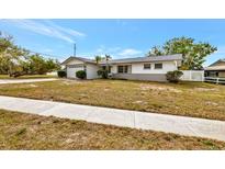 Charming single-story home featuring a well-manicured front yard and attached garage at 14005 Leeward Dr, Seminole, FL 33776