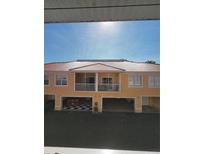 Exterior of a two-story townhome with tile roof, balconies, and garage at 21031 Sunpoint Way # 202, Lutz, FL 33558