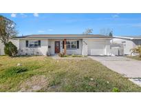 Charming single-story home featuring a classic brick exterior, well-maintained lawn, and an attached garage at 4134 Des Moines Ne St, St Petersburg, FL 33703