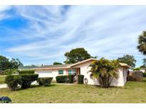 Charming single-story home with a well-manicured lawn, lush landscaping, and lovely curb appeal at 2172 University S Dr, Clearwater, FL 33764