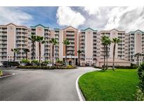 Beautiful condominium building with multiple stories and manicured landscaping on a sunny day at 4516 Seagull Dr # 405, New Port Richey, FL 34652