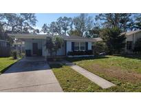 Charming single-story home featuring a cozy carport and a well-maintained front yard at 904 W Braddock St, Tampa, FL 33603