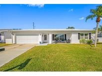 Front view of a charming, single-story home with a covered porch at 4043 93Rd N Ter, Pinellas Park, FL 33782