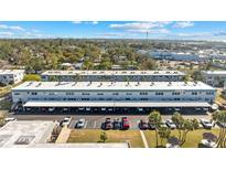 Wide aerial shot of condo buildings, carports, and parking spaces, surrounded by lush trees and landscaping at 5246 81St N St # 6, St Petersburg, FL 33709