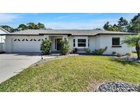 Charming single-story home with a well-maintained lawn and lovely landscaping at 9693 58Th N St, Pinellas Park, FL 33782