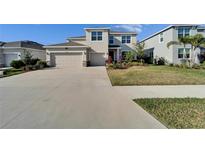 Charming two-story home with a well-manicured lawn and a spacious driveway at 16725 Barnwood Pl, Bradenton, FL 34211