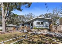 Charming single-story home with a beautifully landscaped front yard and inviting outdoor seating area at 3087 Duane Ave, Oldsmar, FL 34677