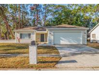 Charming single-story home featuring a well-maintained lawn and an attached two-car garage at 6905 122Nd Dr, Largo, FL 33773