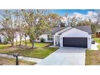 Charming single-story home with well-maintained lawn, and attached two car garage at 7800 Willow Brook Ct, Hudson, FL 34667