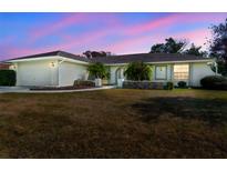 Charming single-story home with well-maintained landscaping, mature trees, and attached two car garage at 10340 Ventura Dr, Spring Hill, FL 34608