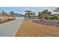 Charming single-story home featuring a well-manicured front yard and a two-car garage at 12341 79Th Pl, Seminole, FL 33772