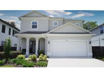 Beautiful two-story home featuring a two car garage, landscaped front yard, and covered porch at 3328 W Palmetto St, Tampa, FL 33607