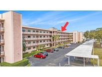 Multi-story condo building with balconies and ample parking at 5980 80Th N St # 410, St Petersburg, FL 33709
