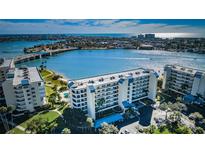 Stunning aerial view of waterfront condo complex with beautiful blue water and city skyline at 7882 Sailboat Key S Blvd # 508, South Pasadena, FL 33707