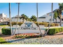Entrance to Captiva Cay with sign and landscaping at 9347 Blind Pass Rd, St Pete Beach, FL 33706
