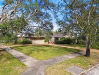 Inviting home with a manicured lawn, mature trees, and well-kept landscaping, offering great curb appeal at 1400 Brightwaters Ne Blvd, St Petersburg, FL 33704