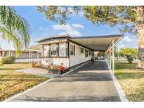 Charming single-story home boasts a covered carport and well-maintained landscaping at 37321 8Th Ave, Zephyrhills, FL 33542