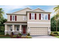 Two-story home featuring red shutters, a two-car garage, and a welcoming front porch at 5636 Silver Moonlight Dr, Palmetto, FL 34221