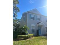 Charming two-story townhome with light blue shutters, front garden, and an inviting front entrance at 8541 Hunters Key Cir, Tampa, FL 33647