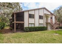 Charming two-story condo with private screened balcony, lush green lawn, and nicely maintained landscaping at 515 Mistletoe Ct # C, Safety Harbor, FL 34695