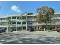 Multi-story building featuring balconies and well-maintained landscaping at 2330 Ecuadorian Way # 10, Clearwater, FL 33763