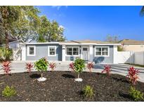 Charming home featuring a well-manicured front yard with new landscaping and concrete driveway at 3213 W Cass St, Tampa, FL 33609